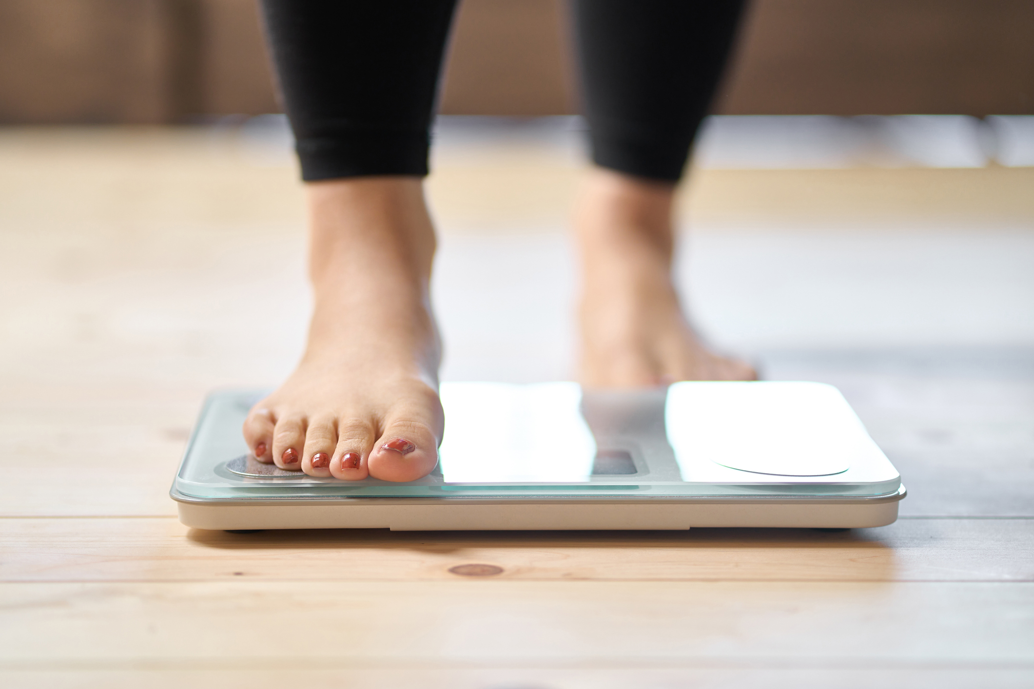 person weighting on scale